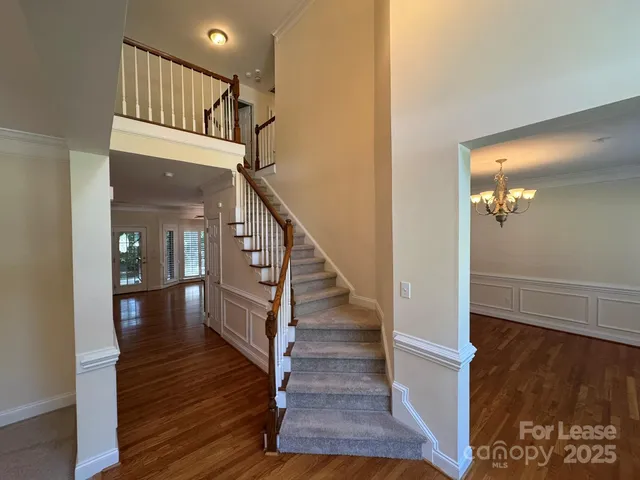 a view of entryway and hall with wooden floor