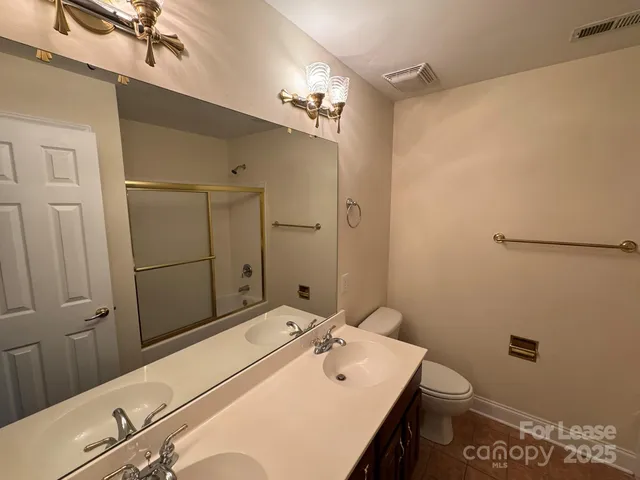 a bathroom with a large tub sink shower and mirror