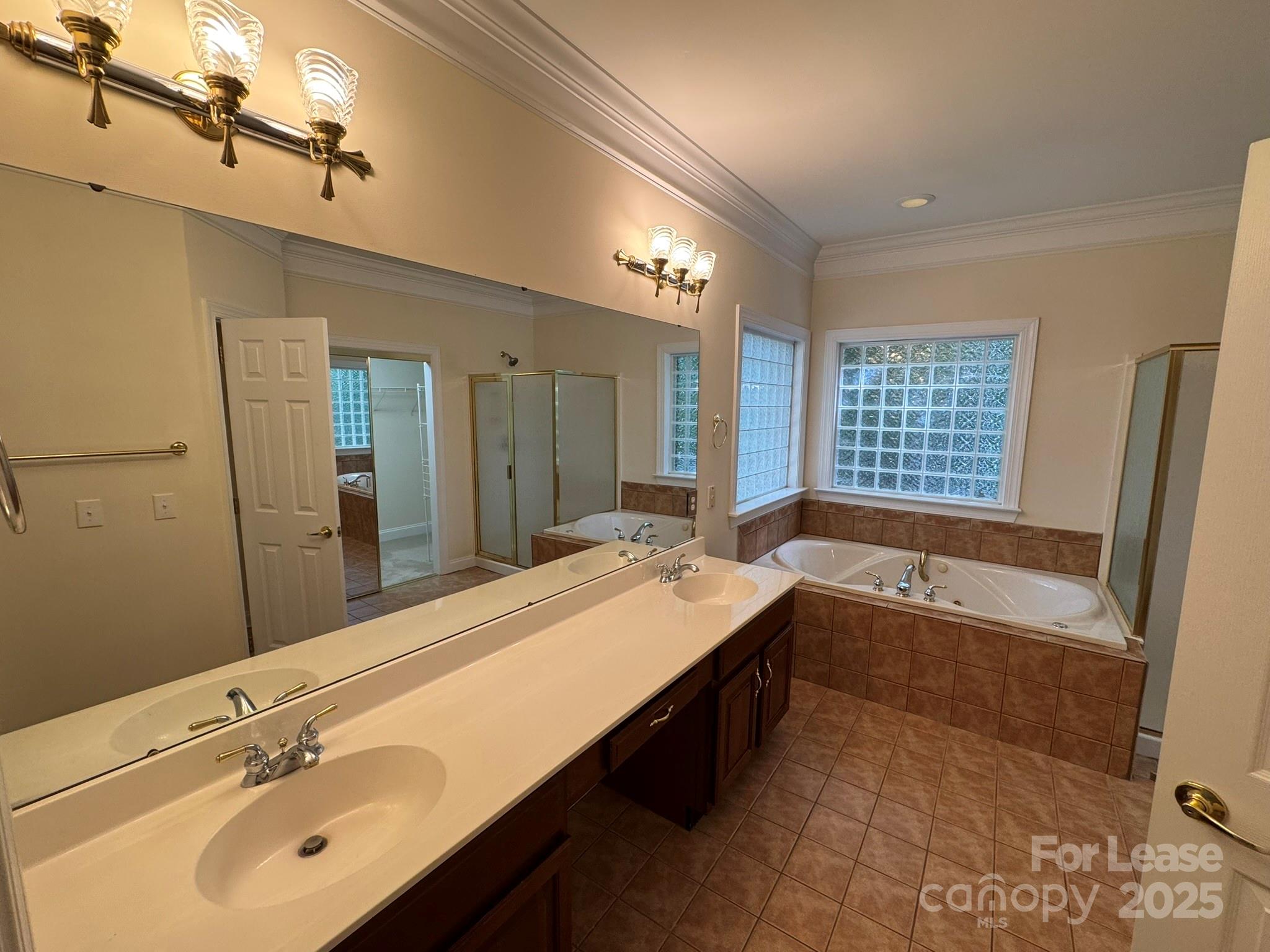 7127 Weddington Brook Drive Matthews, NC 28104 - Photo 25 of 31 a bathroom with a large tub sink shower and mirror