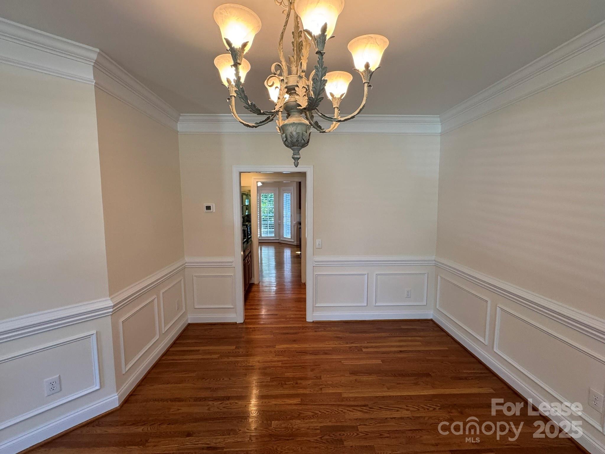 7127 Weddington Brook Drive Matthews, NC 28104 - Photo 6 of 31 a view of an empty room with wooden floor