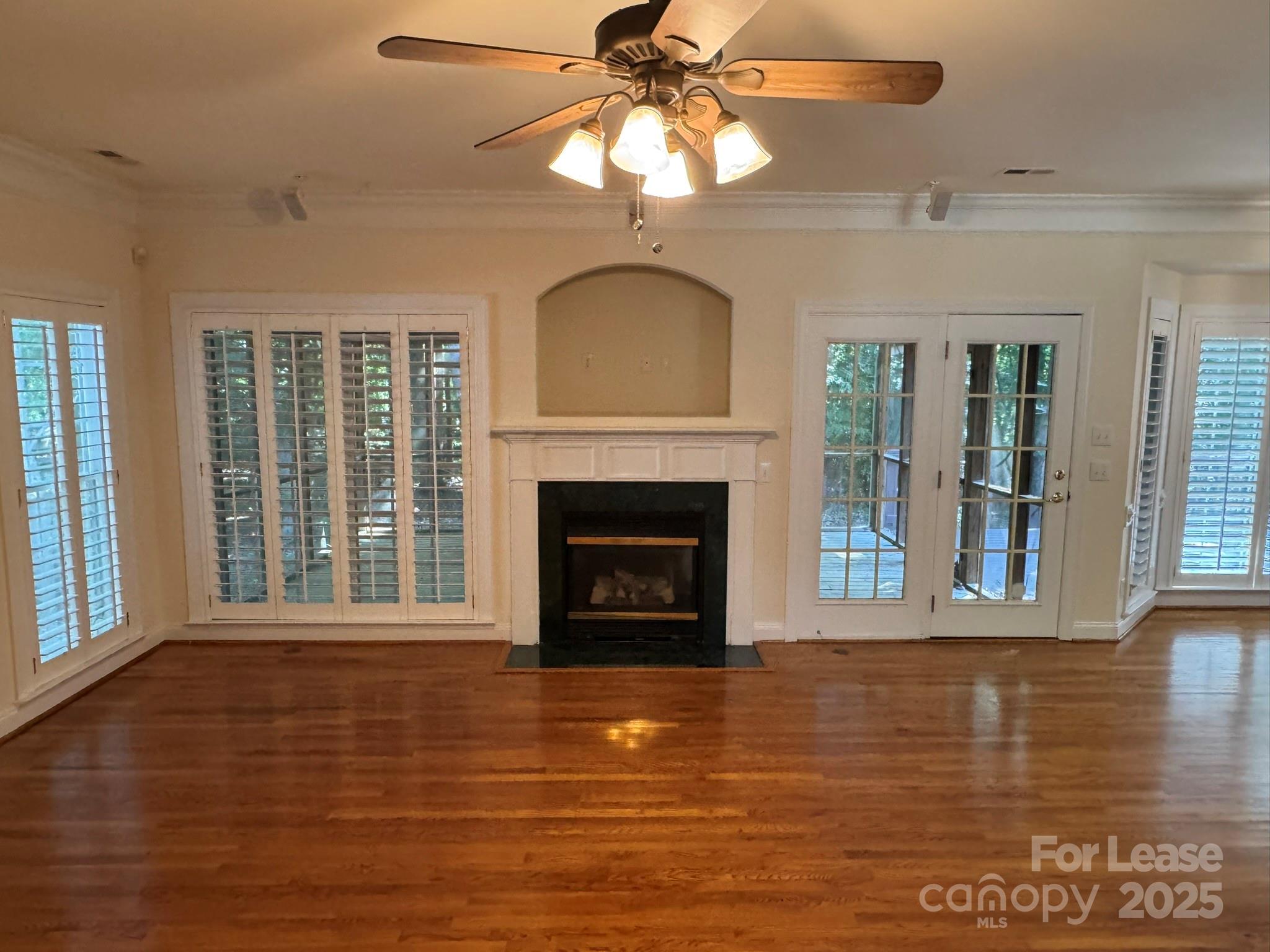 7127 Weddington Brook Drive Matthews, NC 28104 - Photo 7 of 31 a view of a livingroom with a fireplace wooden floor and windows