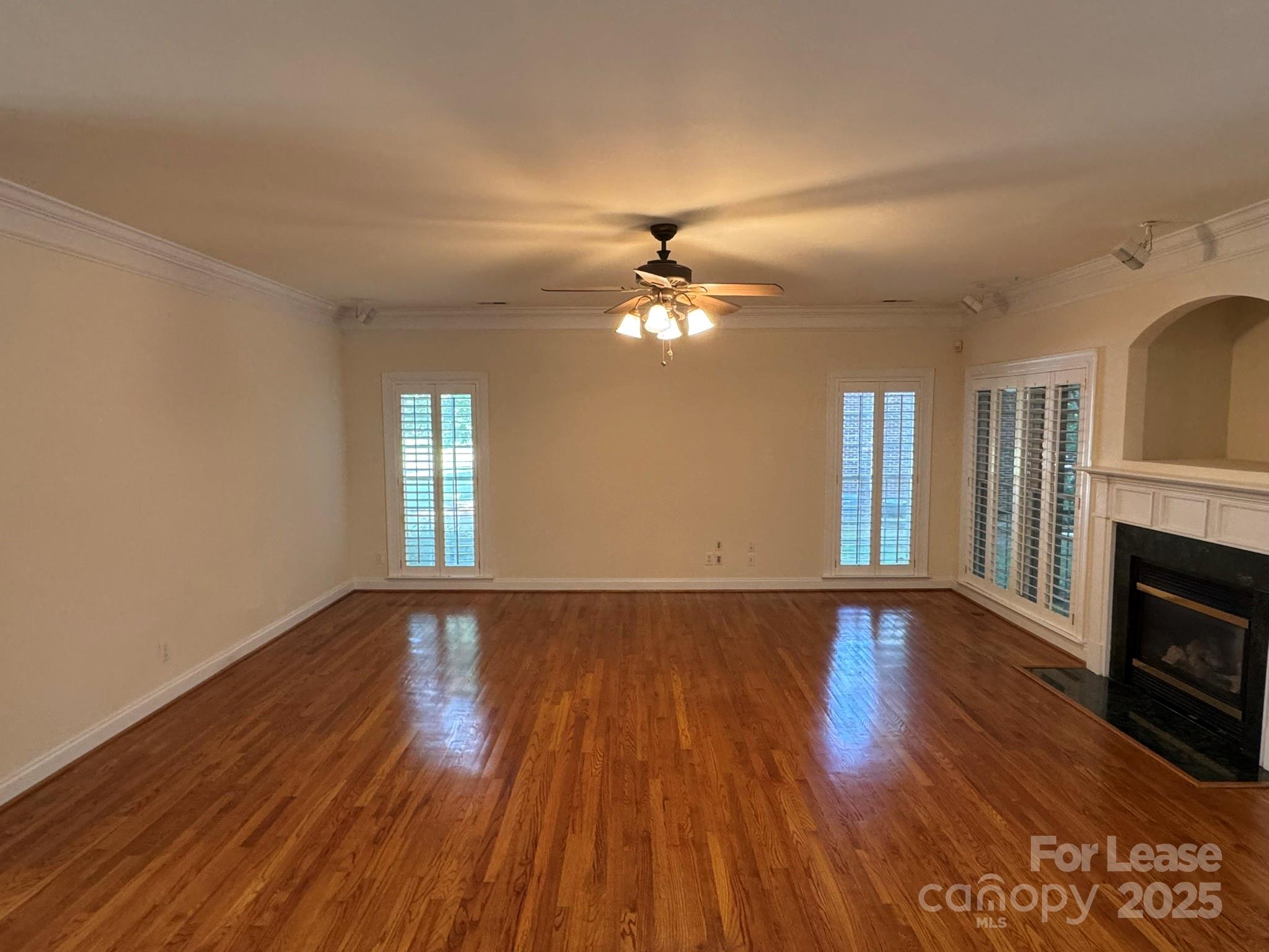 7127 Weddington Brook Drive Matthews, NC 28104 - Photo 8 of 31 a view of an empty room with wooden floor and a window