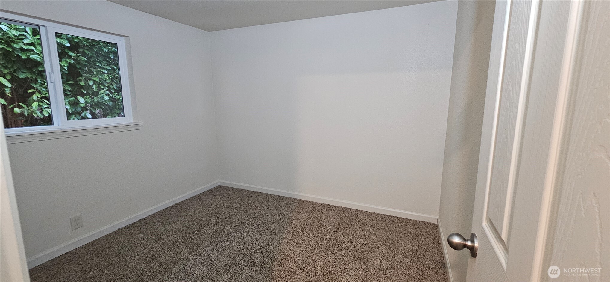 7606 Union Mills Road Southeast Lacey, WA 98503 - Photo 11 of 16 an empty room with a window