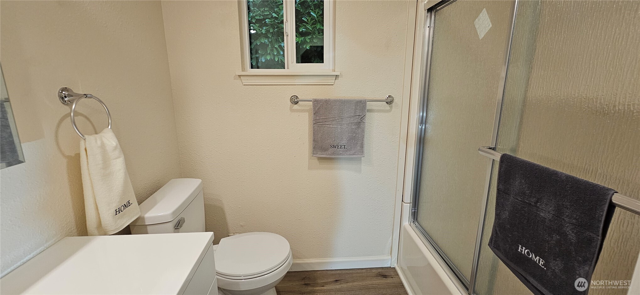 7606 Union Mills Road Southeast Lacey, WA 98503 - Photo 12 of 16 a white toilet sitting next to a bathroom sink and a mirror