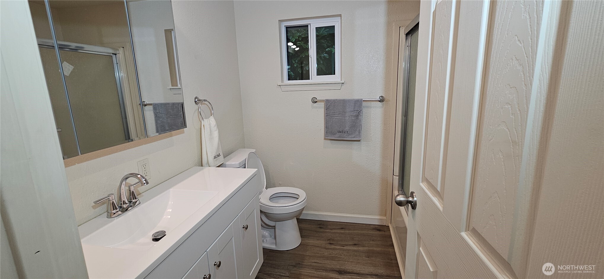 7606 Union Mills Road Southeast Lacey, WA 98503 - Photo 13 of 16 a bathroom with a sink and mirror with toilet