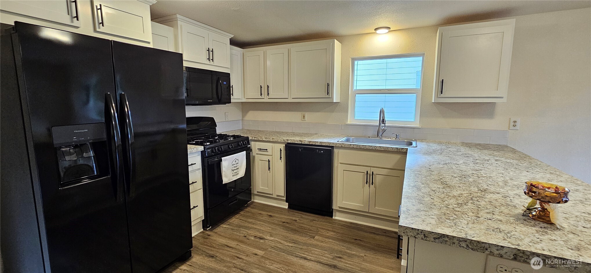 7606 Union Mills Road Southeast Lacey, WA 98503 - Photo 7 of 16 a kitchen with a sink stainless steel appliances and cabinets