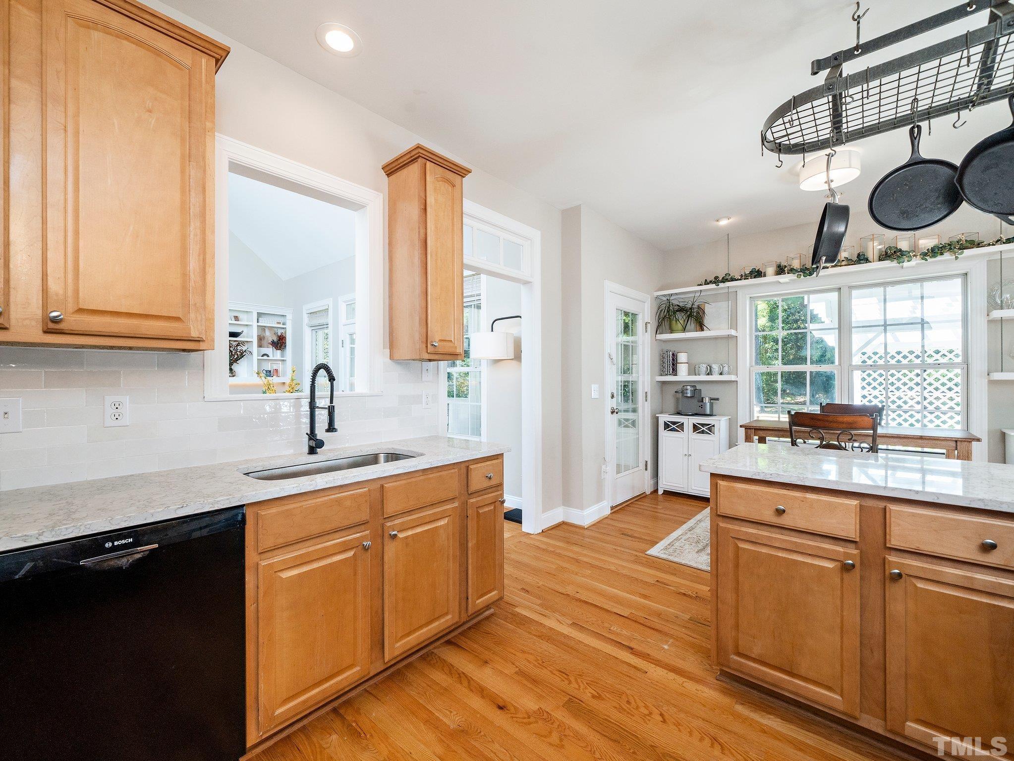 1236 Torchlight Way Raleigh, NC 27603 - Photo 12 of 39 a kitchen with stainless steel appliances granite countertop a sink and cabinets with wooden floor