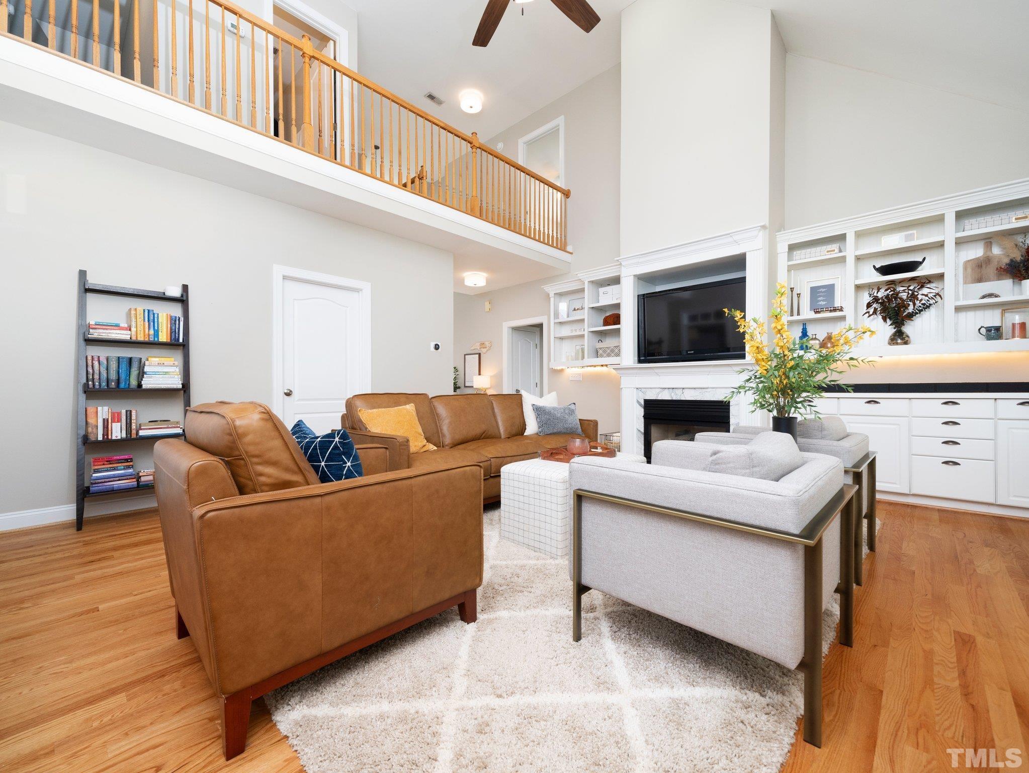 1236 Torchlight Way Raleigh, NC 27603 - Photo 7 of 39 a living room with furniture a flat screen tv and a fireplace