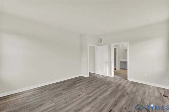 a view of an empty room and wooden floor