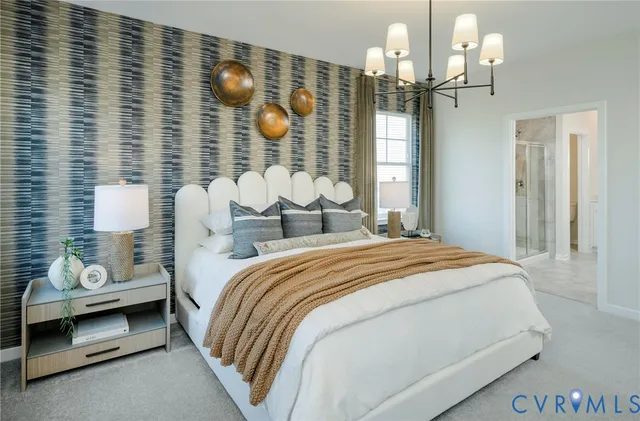 a bedroom with bed and a chandelier