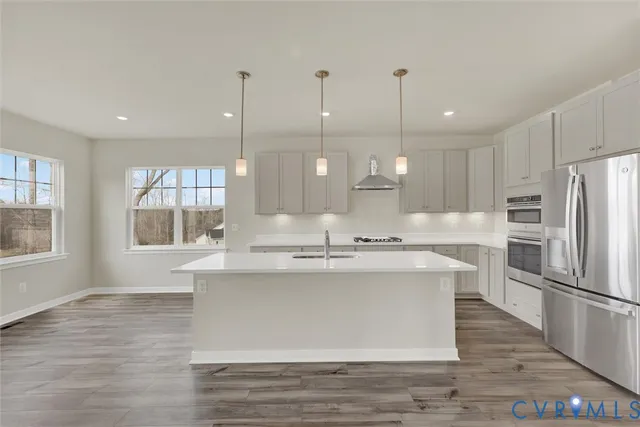 a kitchen with kitchen island a sink stainless steel appliances and window