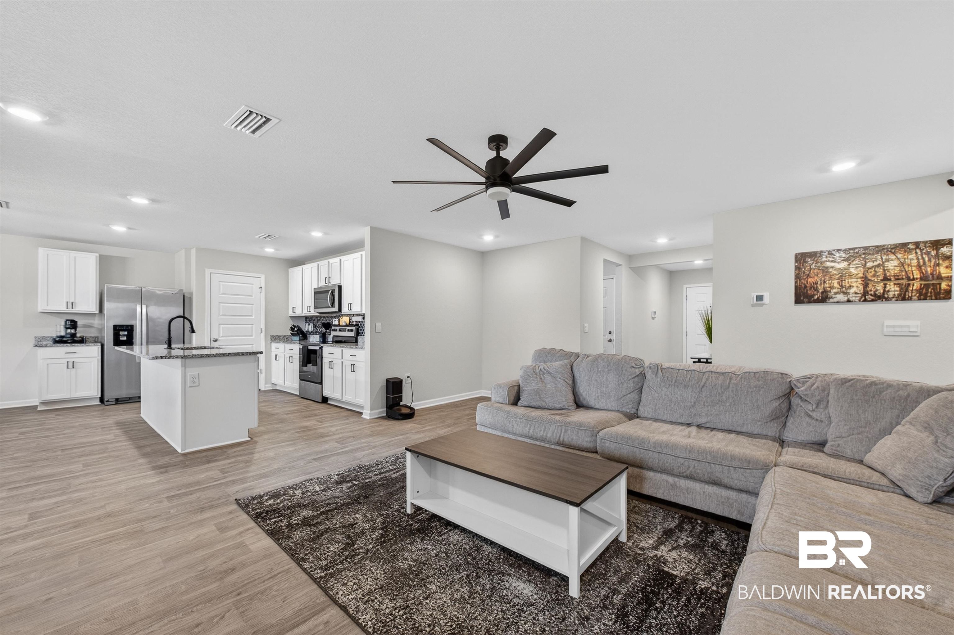 3213 Camino Real Loop Lillian, AL 36549 - Photo 24 of 61 Open-concept living space featuring wood-finish flooring and recessed lighting