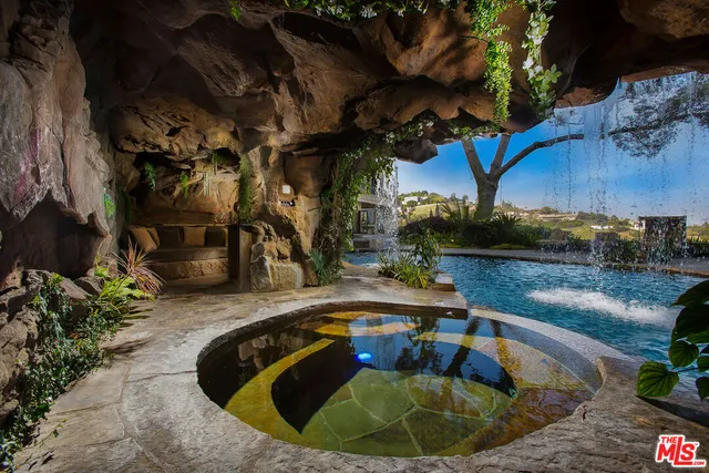 a swimming pool with outdoor seating and yard