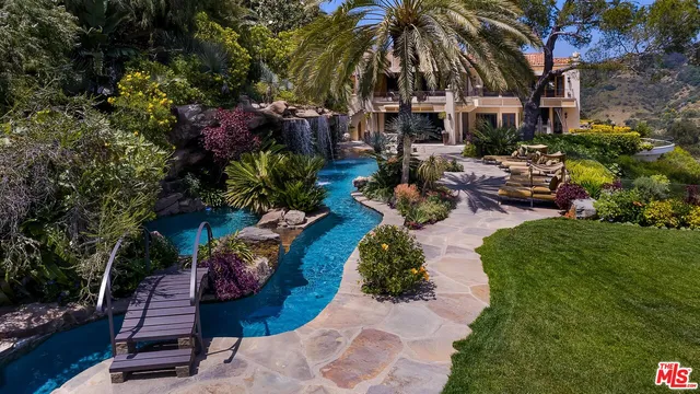 an aerial view of multiple houses with a yard