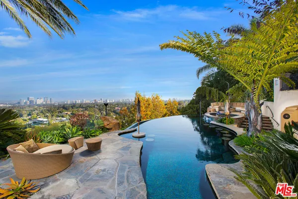 an outdoor living area with furniture and a garden