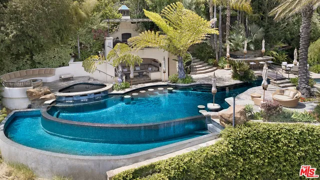 an aerial view of a house with a garden and lake view