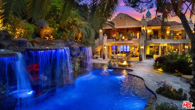 a view of a house with swimming pool and sitting area