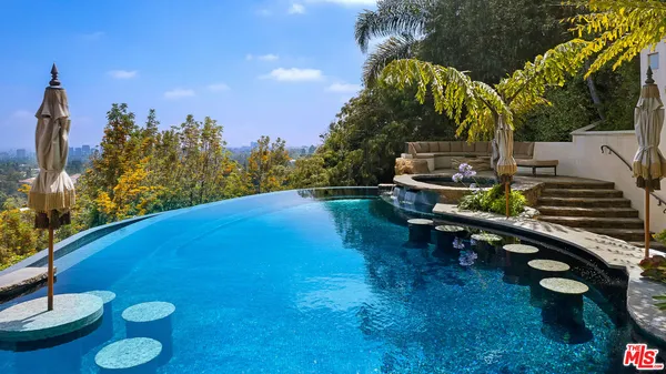 an aerial view of a house with yard swimming pool and outdoor seating