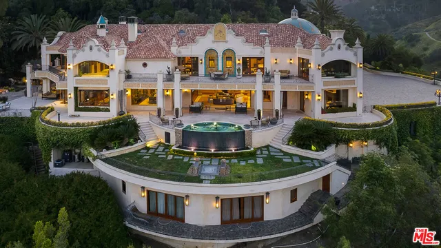 a view of a house with pool and chairs