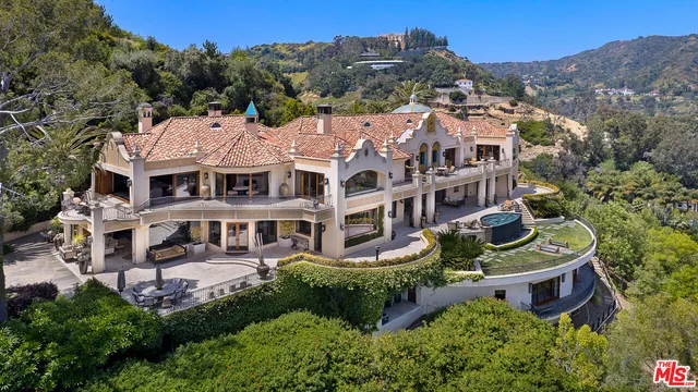 a room with pool table and windows
