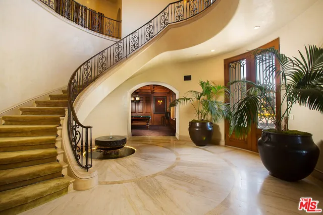 a living room with couch and a chandelier