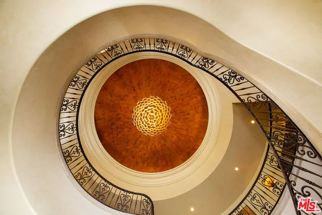 a living room with furniture a flat screen tv and floor to ceiling window