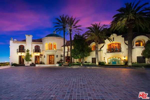 a front view of multiple houses with yard