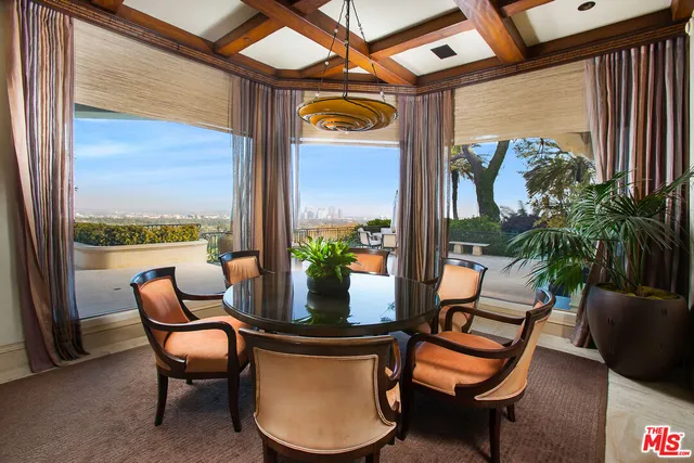 a bedroom with furniture and a large window