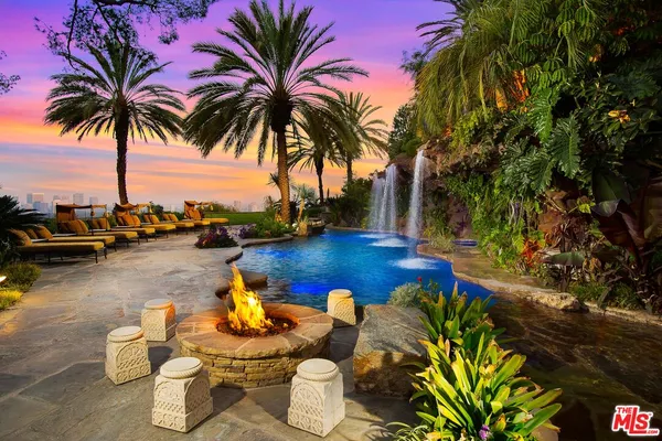 a view of a lake with couches and swimming pool