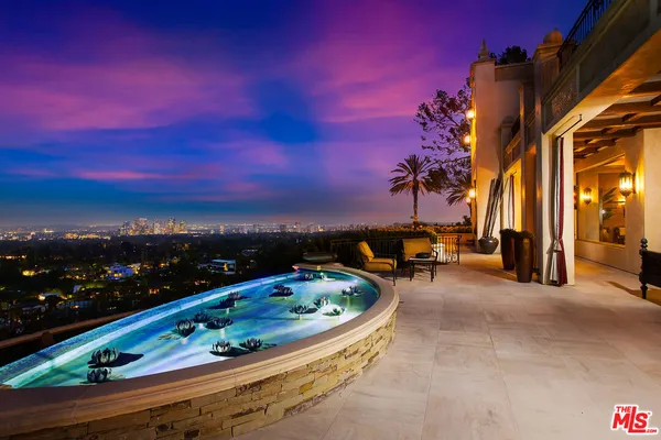 a row of palm trees sitting in front of a house