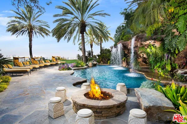 an aerial view of a house with yard swimming pool and outdoor seating