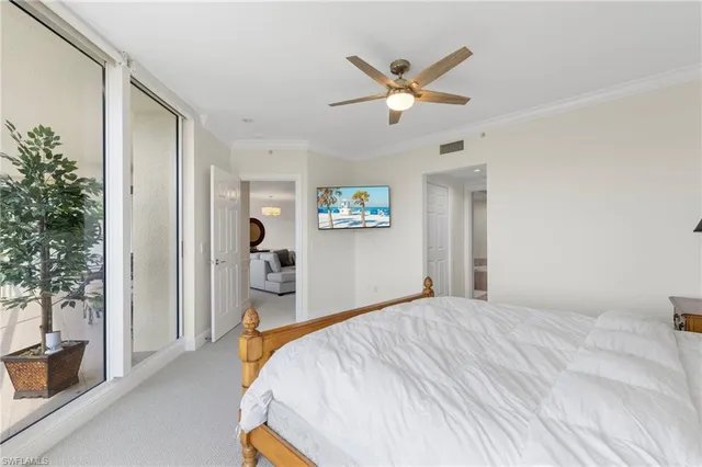 a bedroom with a large bed and a chandelier