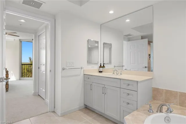 a bathroom with a double vanity sink and mirror