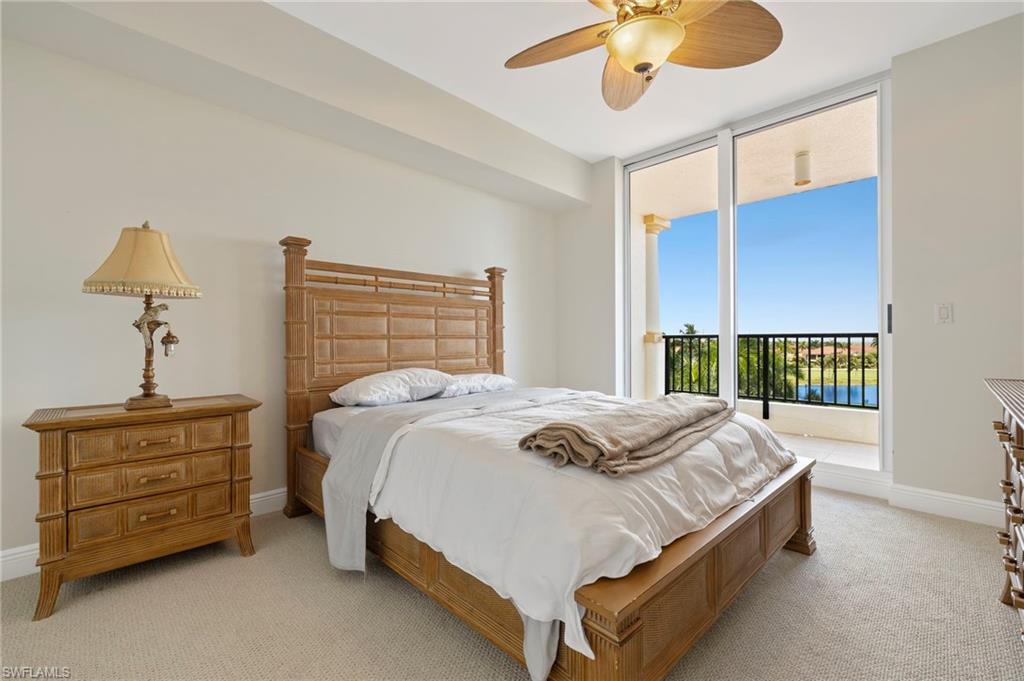 1065 Borghese Lane, Unit 403 Naples, FL 34114 - Photo 19 of 30 a bed sitting in a bedroom next to a window