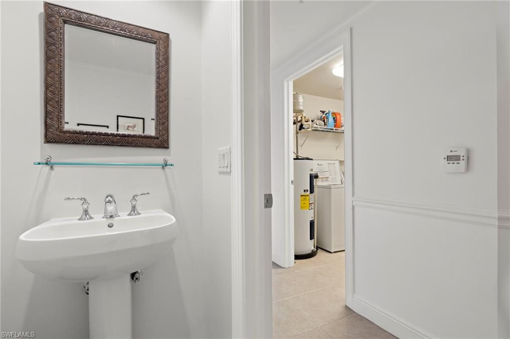 1065 Borghese Lane, Unit 403 Naples, FL 34114 - Photo 21 of 30 a bathroom with a sink and mirror