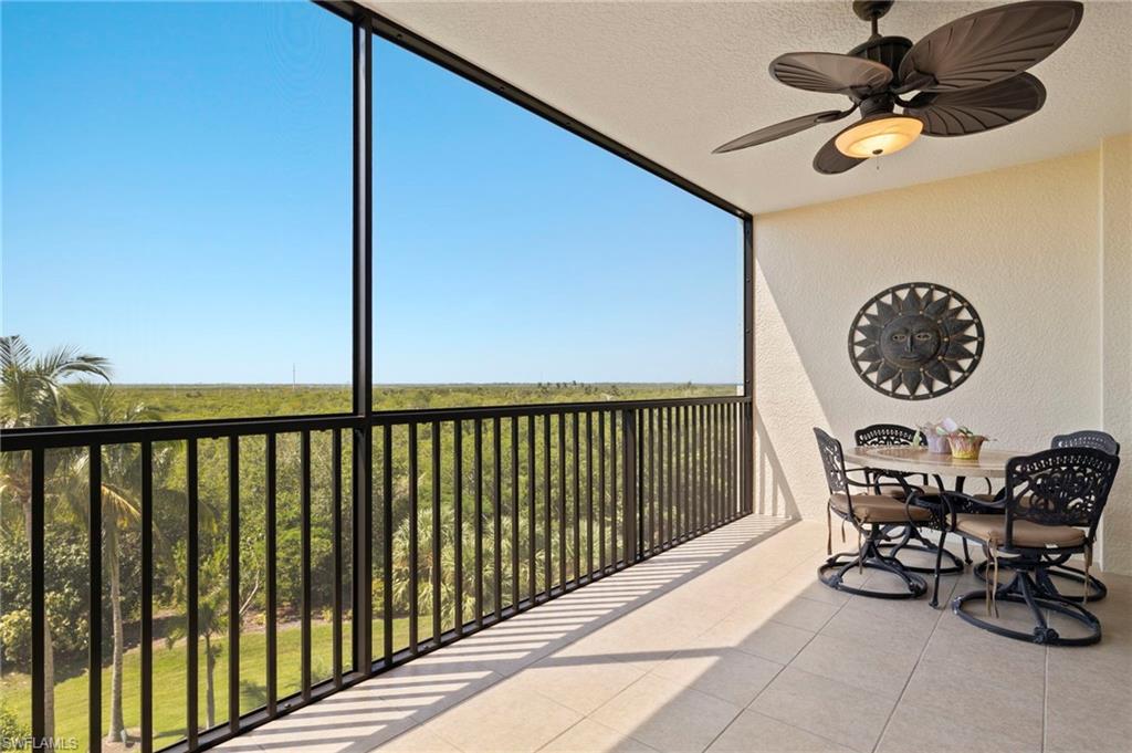 1065 Borghese Lane, Unit 403 Naples, FL 34114 - Photo 22 of 30 a view of a chairs and table in a room