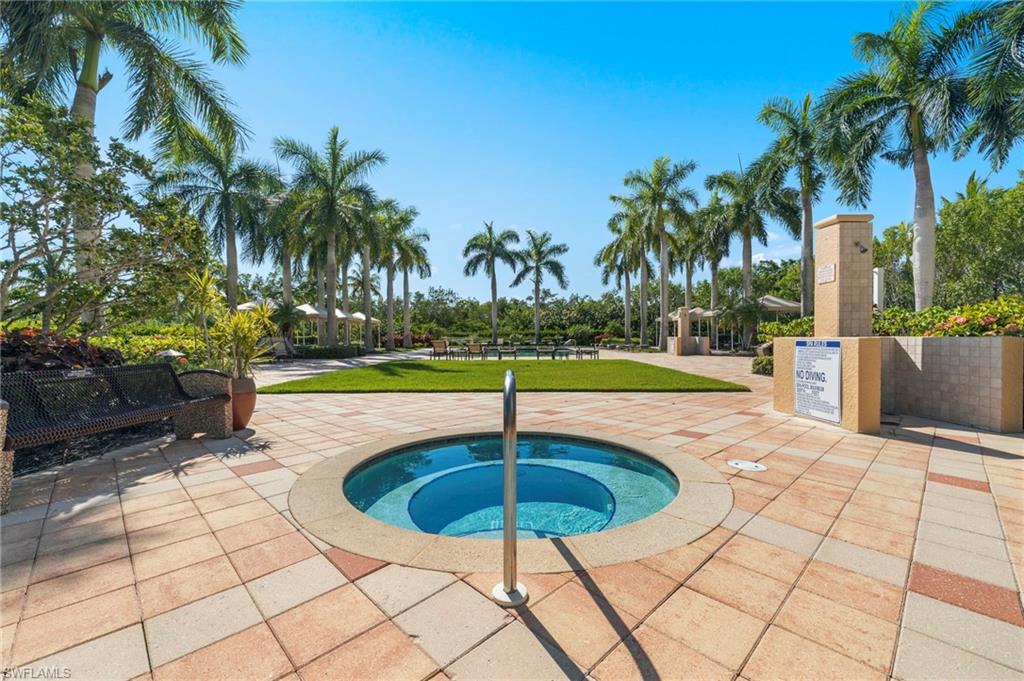 1065 Borghese Lane, Unit 403 Naples, FL 34114 - Photo 27 of 30 a swimming pool with a yard and palm trees