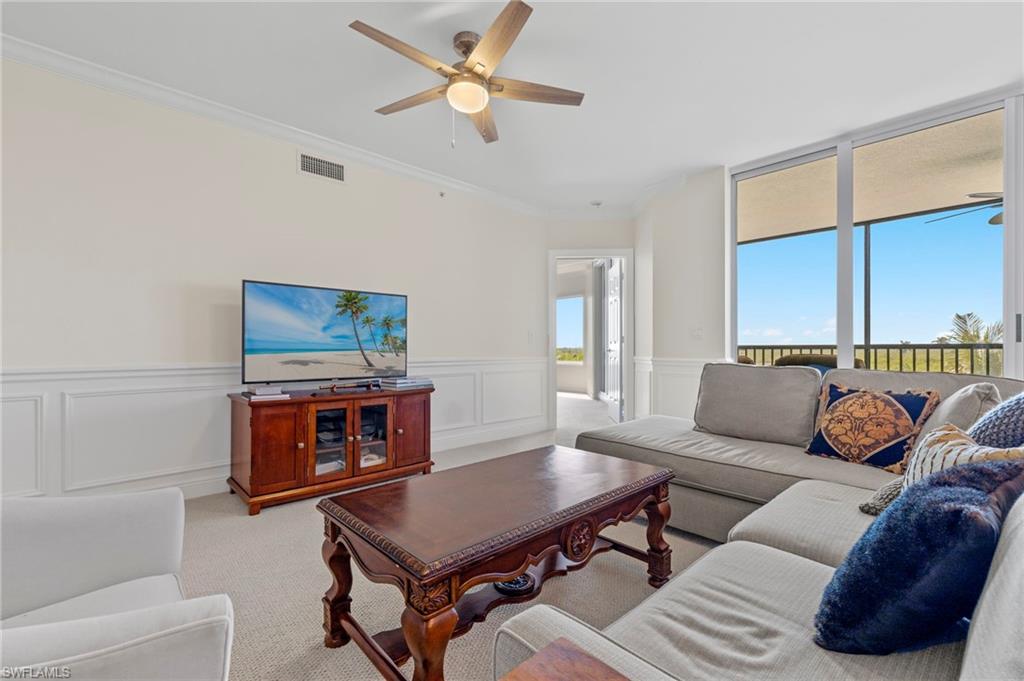 1065 Borghese Lane, Unit 403 Naples, FL 34114 - Photo 5 of 30 a living room with furniture and a flat screen tv
