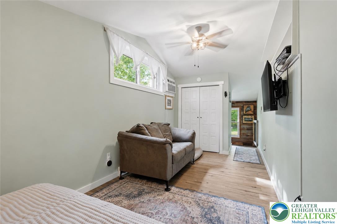 9033 Loop Road Slatington, PA 18080 - Photo 30 of 53 A cozy bedroom features a stylish ceiling fan, ample natural light, and durable hardwood flooring.