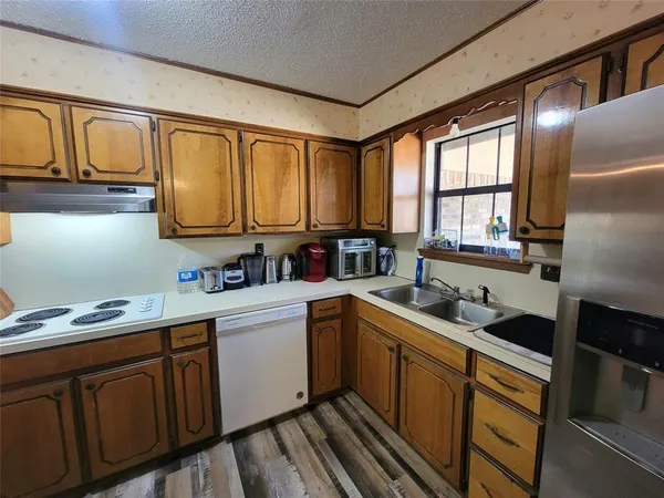 a kitchen with stainless steel appliances granite countertop a sink stove and cabinets