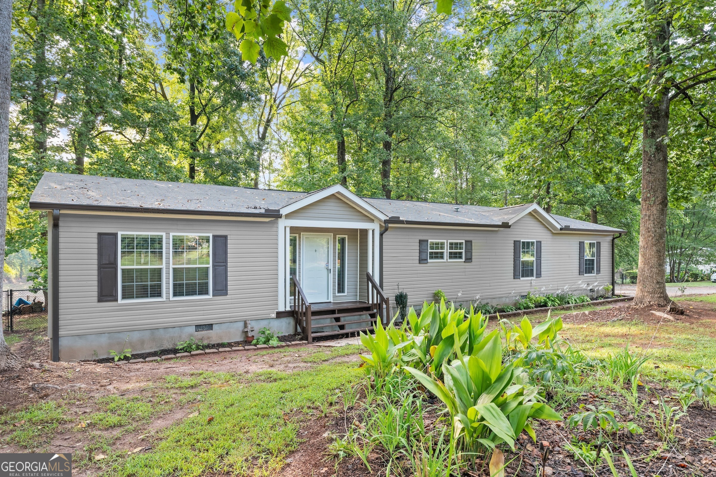 280 Quail Ridge Drive Nicholson, GA 30565 - Photo 1 of 1 a front view of a house with garden