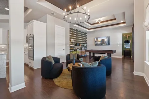 a living room with furniture potted plant and a large window