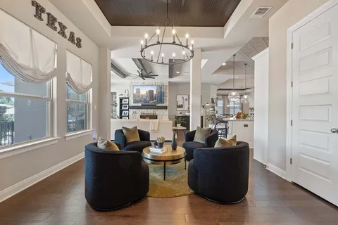 a living room with furniture and a chandelier