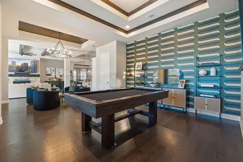 a view of a dining room with furniture a chandelier and wooden floor