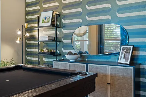 a room with pool table and wooden floor