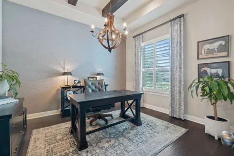 a dining room with furniture a chandelier and wooden floor