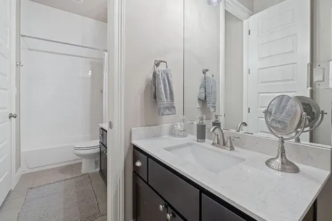 a bedroom with a bed and a chair