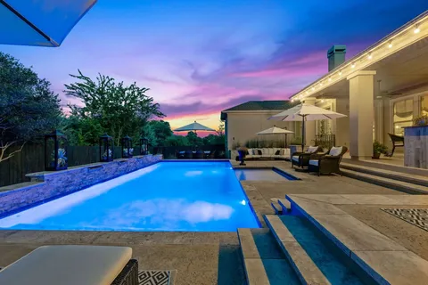 a living room with furniture a table and chairs