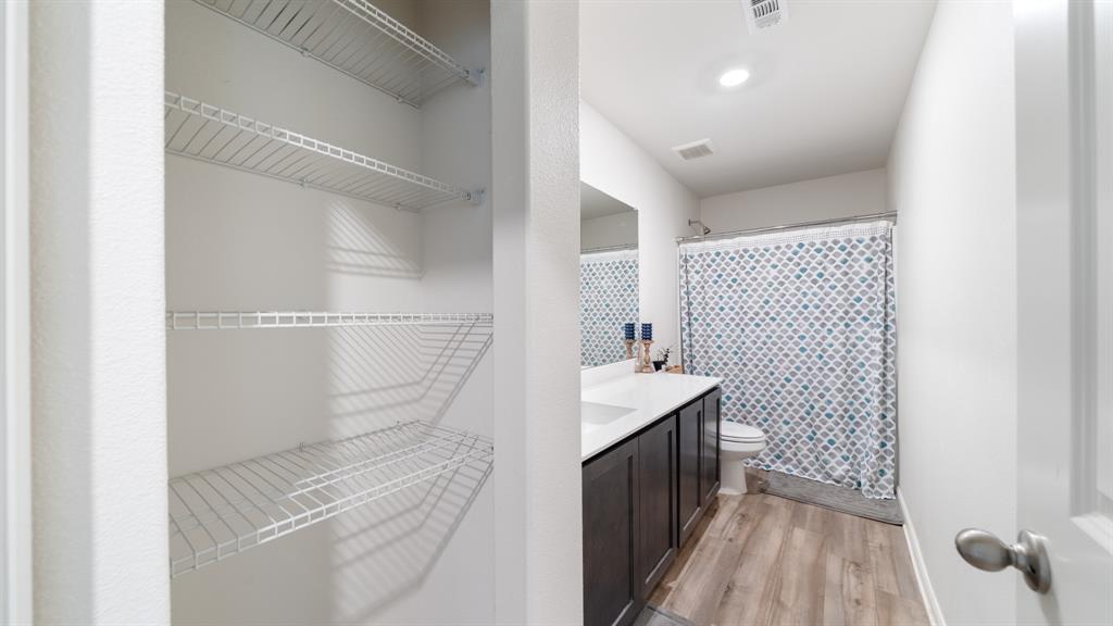 408 Micah Lane Ferris, TX 75125 - Photo 15 of 19 a bathroom with a sink a toilet and shower