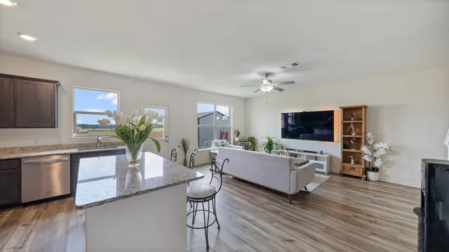 a living room with furniture flat screen tv and wooden floor